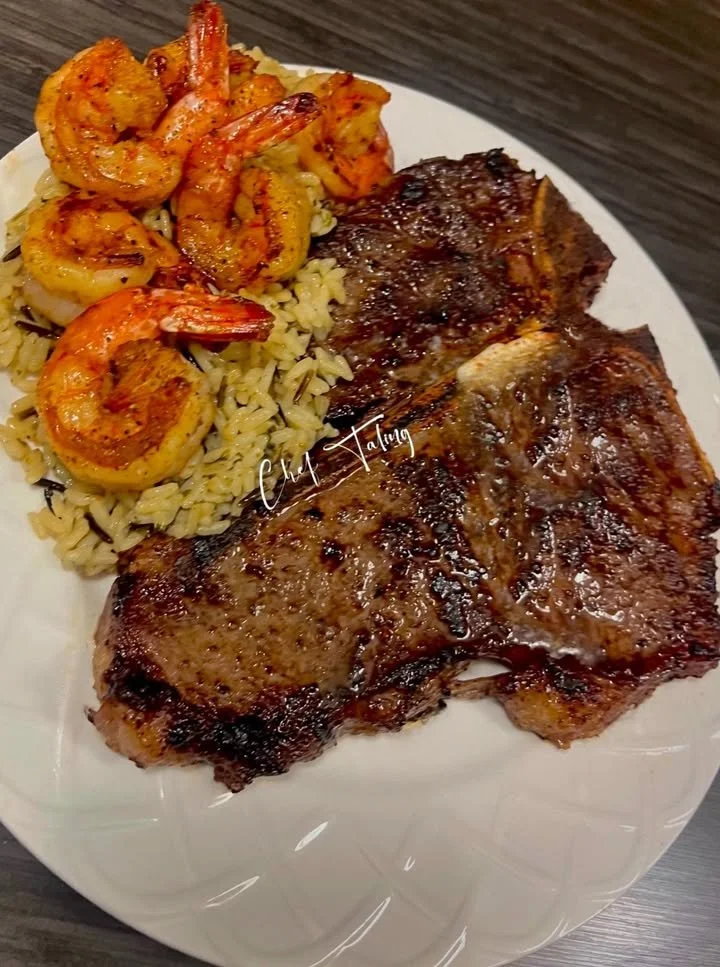 Delicious plate of Steak & Honey Shrimp over garlic butter wild rice
