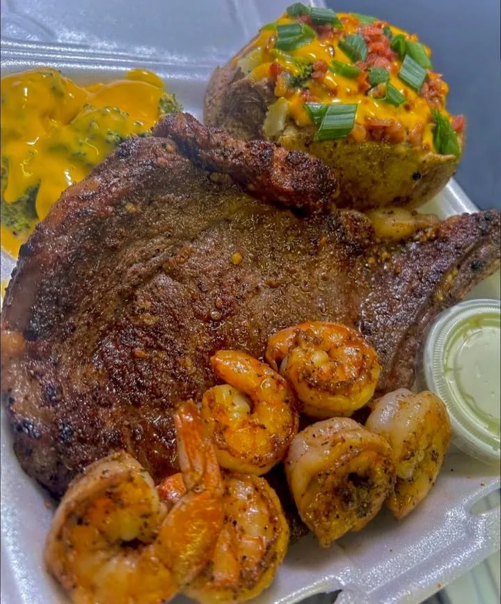 Delicious steak & shrimp dish served with fresh vegetables and herbs