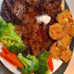 Delicious Steak & Shrimp breakfast platter with eggs and vegetables