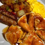Delicious Sunday breakfast spread with pancakes, eggs, and fresh fruits.