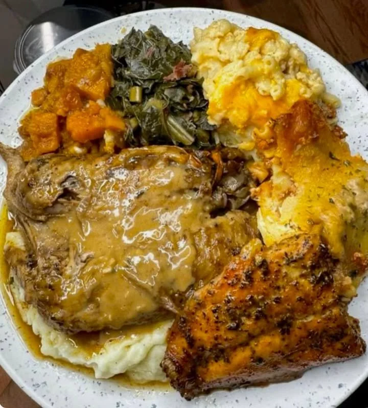 A vibrant plate of soul food featuring fried chicken, collard greens, and cornbread.