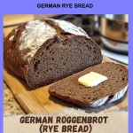 Freshly baked German Rye Bread sliced on a wooden board.