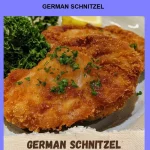 Delicious German Schnitzel served with lemon and herbs on a plate