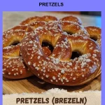 Pretzels Freshly baked pretzels sprinkled with coarse salt on a wooden table