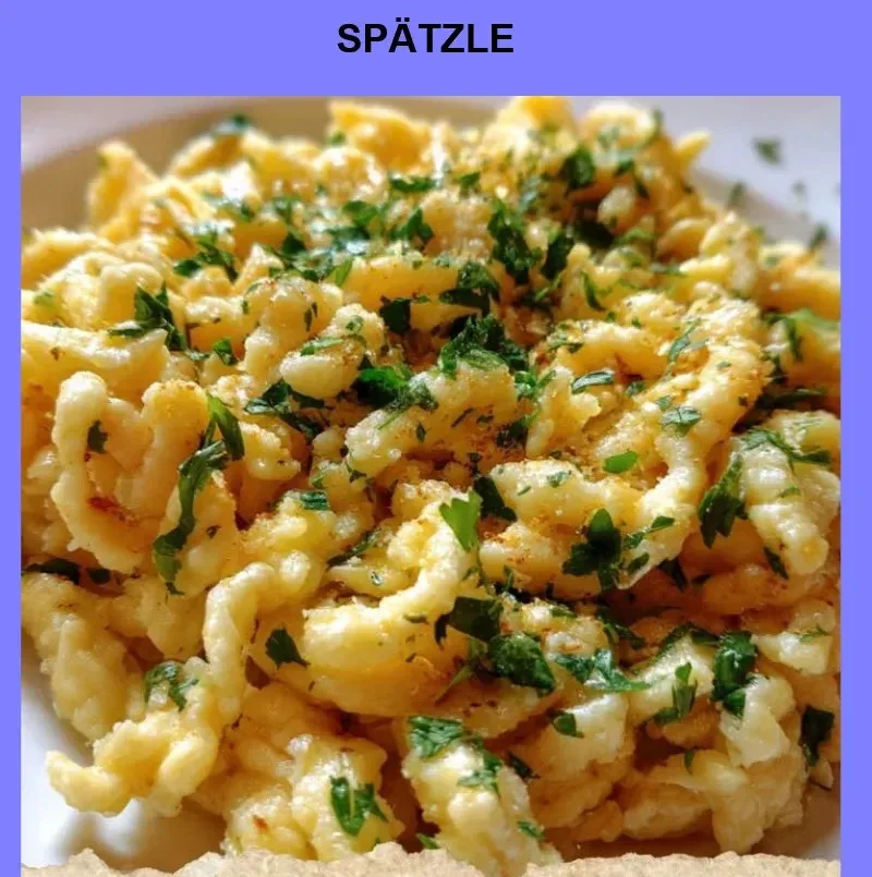 Delicious homemade Spätzle served on a plate with herbs.
