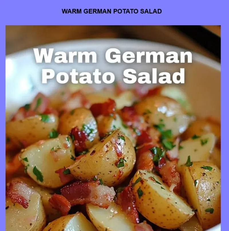 Bowl of warm German potato salad garnished with herbs and bacon