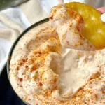 Delicious crawfish salad sandwich with fresh ingredients and a side of greens