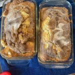 Slice of homemade garden zucchini bread topped with nuts