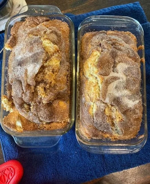 Slice of homemade garden zucchini bread topped with nuts