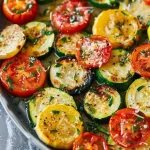 Oven-Roasted Zucchini, Squash, and Tomatoes with Parmesan Oven-roasted zucchini, squash, and tomatoes with Parmesan cheese on a serving dish