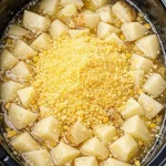 Bowl of creamy slow cooker potato soup with herbs and toppings