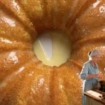 Super easy moist cake with frosting and decorations on a serving plate.