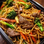 Delicious bowl of Beef Lo Mein with stir-fried noodles and vegetables.