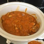 Slow cooker chicken curry in a bowl with aromatic spices and vegetables