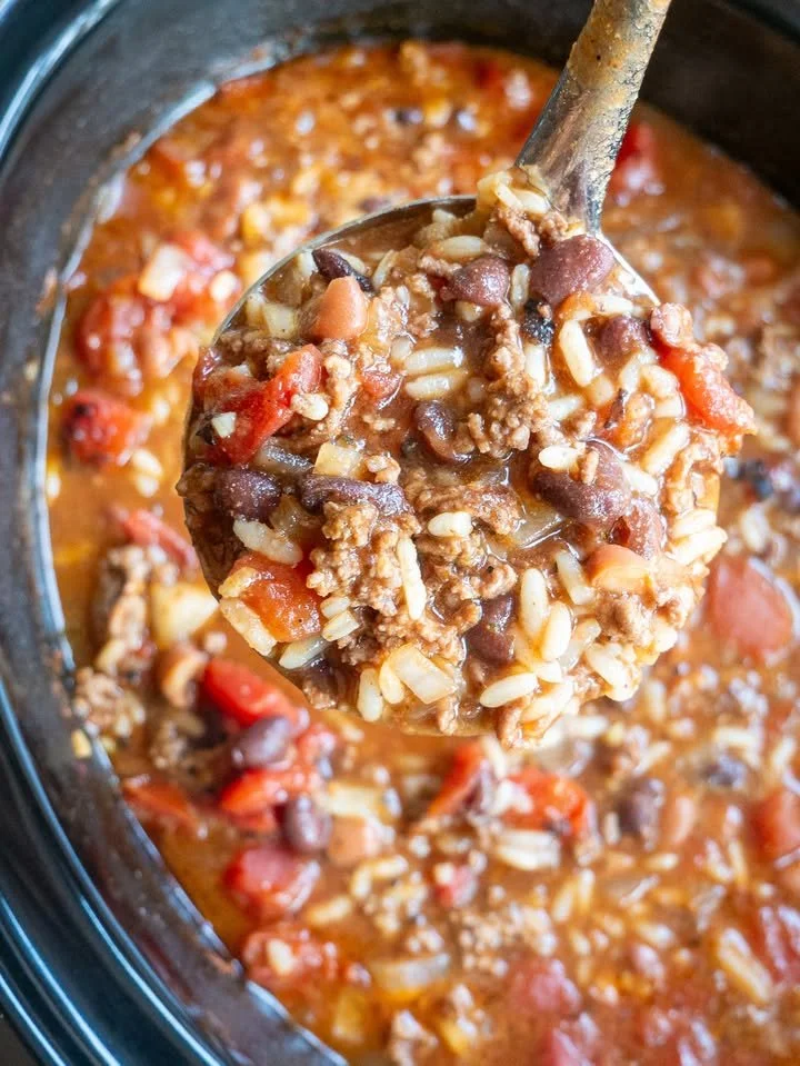 A bowl of hearty Crockpot Soup filled with vegetables and spices.