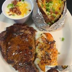 Delicious loaded baked potato topped with cheese, bacon, and chives