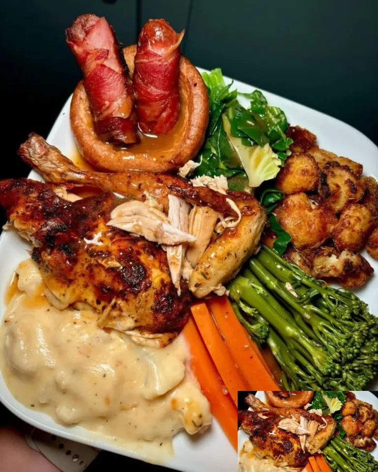 A golden-brown roast chicken served with vegetables on a dinner table