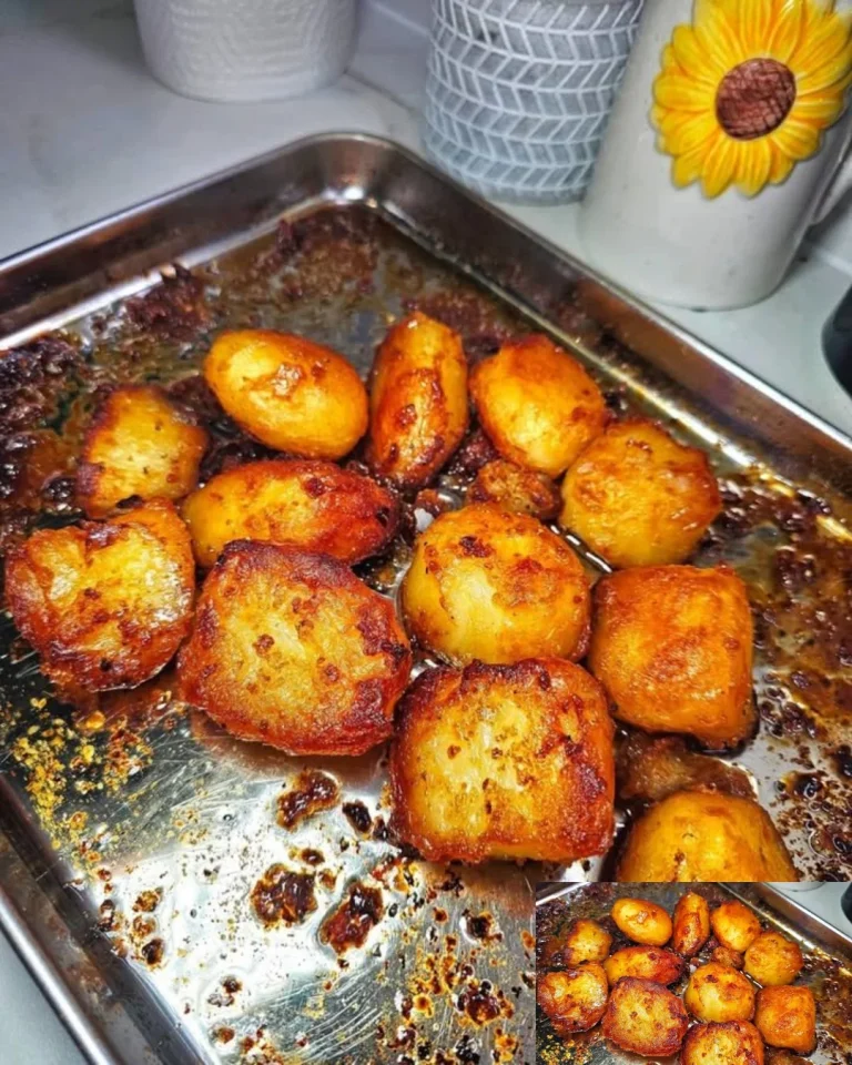 Golden crispy roast potatoes served in a bowl, ideal for dinner sides.