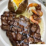 Grilled steak and shrimp served together on a plate
