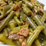 Fresh green beans on a wooden cutting board ready for cooking