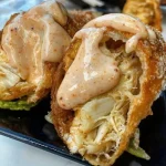 Crispy crab cake egg rolls served with dipping sauce