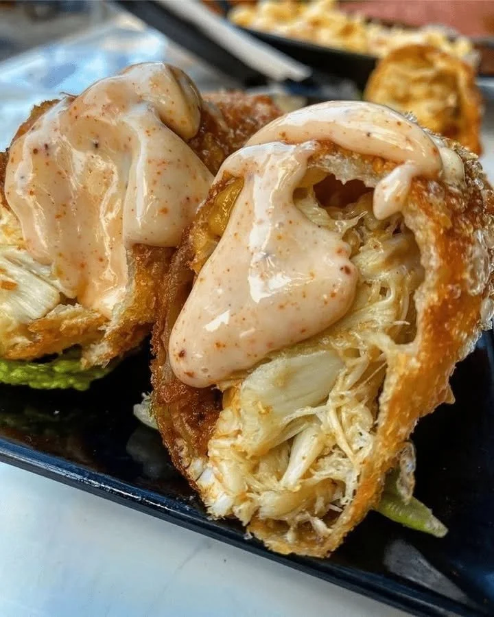 Crispy crab cake egg rolls served with dipping sauce