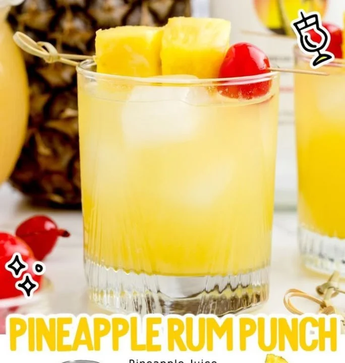 Refreshing Pineapple Rum Punch cocktail garnished with pineapple slices
