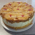 Delicious Pineapple Upside-Down Cheesecake topped with caramelized pineapples and cherries
