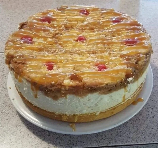 Delicious Pineapple Upside-Down Cheesecake topped with caramelized pineapples and cherries