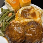 Delicious Salisbury steak topped with savory onion gravy served on a plate.