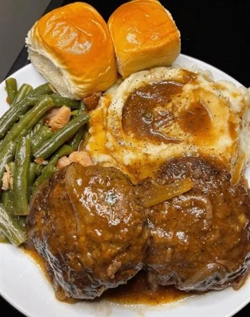 Delicious Salisbury steak topped with savory onion gravy served on a plate.
