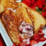 Delicious Strawberry French Toast Roll-Ups served on a plate